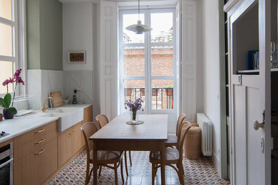 Example of a small danish single-wall ceramic tile eat-in kitchen design in Madrid with a double-bowl sink, marble countertops, white backsplash, stone slab backsplash, no island and stainless steel appliances