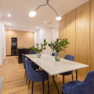 Foto de comedor actual con paredes blancas, suelo de madera en tonos medios y suelo marrón