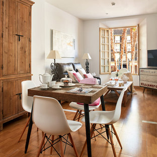 Inspiration for a mid-sized shabby-chic style open plan dining in Malaga with white walls, medium hardwood floors and no fireplace.