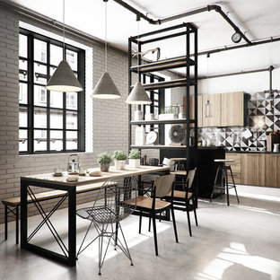 Foto di una sala da pranzo aperta verso la cucina industriale di medie dimensioni con nessun camino e pareti bianche