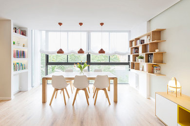 Photo of a medium sized scandi open plan dining room in Barcelona with multi-coloured walls, medium hardwood flooring and no fireplace.
