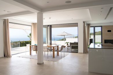 Inspiration for a large mediterranean open plan dining room in Palma de Mallorca with white walls.