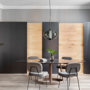 Ejemplo de comedor contemporáneo, cerrado, con paredes grises, suelo de madera clara y suelo beige