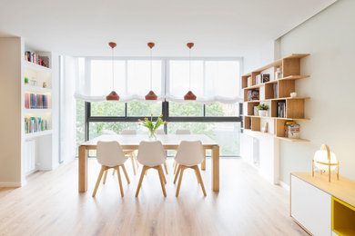 Design ideas for a medium sized scandi open plan dining room in Barcelona with white walls, light hardwood flooring and no fireplace.