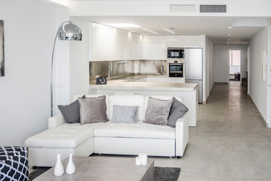 Ejemplo de comedor de cocina minimalista de tamaño medio con paredes grises, suelo de cemento y suelo gris