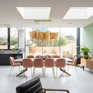 Photo of a medium sized contemporary kitchen/dining room in London with green walls, concrete flooring and grey floors.