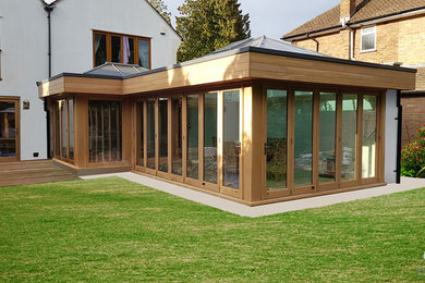 This is an example of a large contemporary conservatory in Surrey with a skylight.