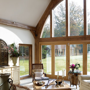 Traditional conservatory in Surrey with a skylight and beige floors.