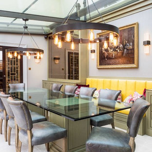 Medium sized bohemian conservatory in London with grey floors and a glass ceiling.