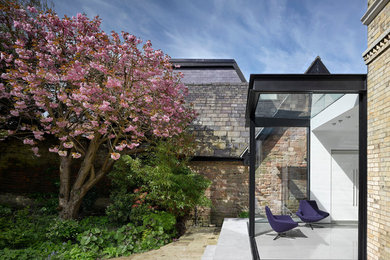 Inspiration for a small contemporary conservatory in Manchester with slate flooring, a glass ceiling and grey floors.