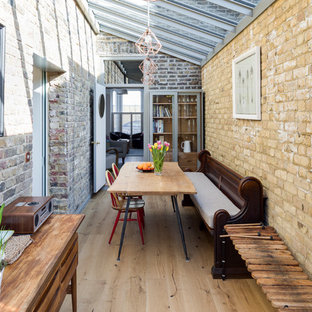 Photo of a medium sized bohemian conservatory in London with light hardwood flooring, beige floors, no fireplace and a glass ceiling.