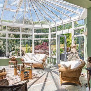 Photo of a medium sized world-inspired conservatory in Other with a standard ceiling and grey floors.