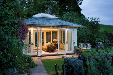 Design ideas for a small traditional conservatory in Other with carpet, a skylight and grey floors.