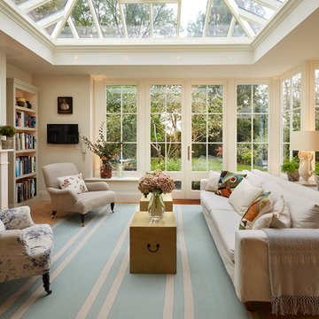 Open plan orangery extension with fireplace (and bespoke dog windows)