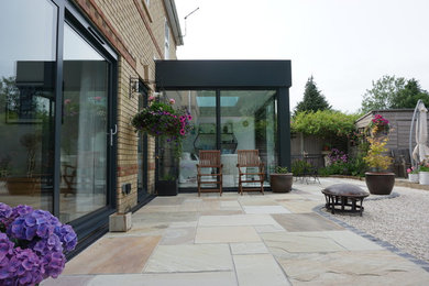 Photo of a small modern conservatory in Dorset with ceramic flooring, a skylight and white floors.