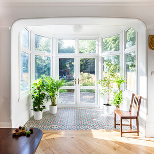 Contemporary conservatory in London with ceramic flooring, a standard ceiling and multi-coloured floors.