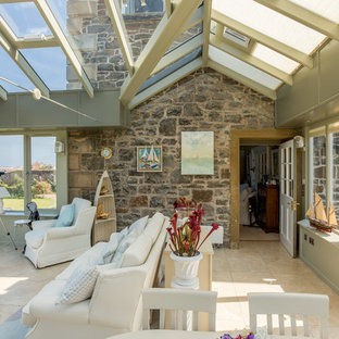 Stilted orangery with glazed balcony and seaside view