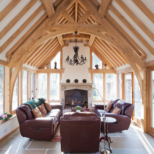 This is an example of a country conservatory in Other with a wood burning stove, grey floors and a standard ceiling.