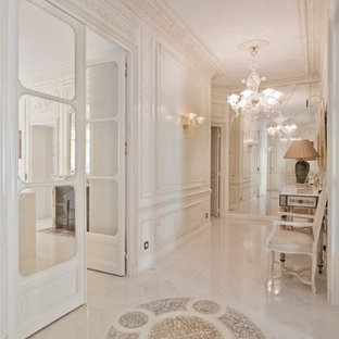 Idée de décoration pour un grand couloir tradition avec un mur beige et un sol en marbre.
