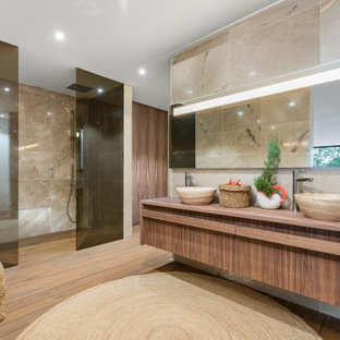 Foto de cuarto de baño principal, doble y flotante, contemporáneo, extra grande, con armarios con paneles lisos, puertas de armario de madera oscura, ducha empotrada, baldosas y/o azulejos beige, paredes beige, lavabo sobreencimera, encimera de madera, suelo marrón y encimeras marrones