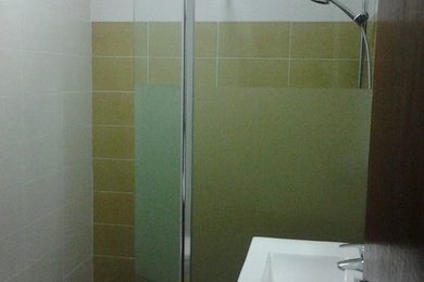 Small classic shower room bathroom in Other with an alcove shower, multi-coloured walls and an integrated sink.