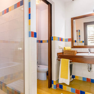 Diseño de cuarto de baño mediterráneo con ducha empotrada, bidé, baldosas y/o azulejos multicolor, paredes blancas, lavabo encastrado, encimera de madera, suelo marrón, ducha con puerta con bisagras y encimeras marrones