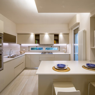 Foto di una grande cucina minimalista chiusa con lavello a doppia vasca, ante lisce, ante beige, paraspruzzi beige, elettrodomestici in acciaio inossidabile, parquet chiaro e penisola
