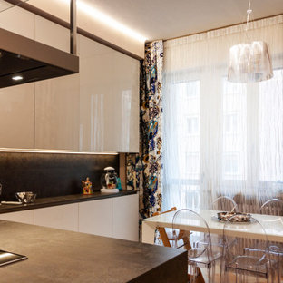 This is an example of a large contemporary l-shaped open plan kitchen in Bologna with glass-front cabinets, beige cabinets, solid surface benchtops, grey splashback, black appliances, marble floors, with island, pink floor, grey benchtop and recessed.