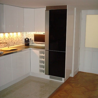 Design ideas for an expansive contemporary l-shaped eat-in kitchen in Denver with a drop-in sink, flat-panel cabinets, zinc benchtops, multi-coloured splashback, mosaic tile splashback and ceramic floors.
