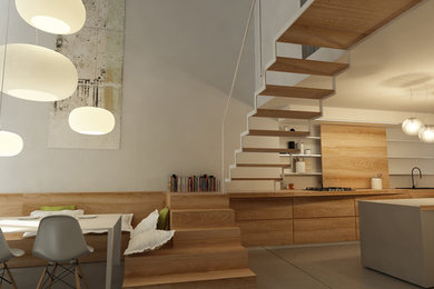 Foto di una cucina minimalista di medie dimensioni con lavello da incasso, ante in legno chiaro e pavimento in cemento