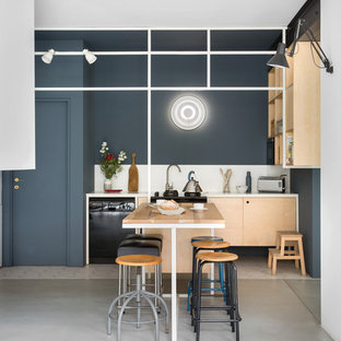 Contemporary open concept kitchen pictures - Open concept kitchen - contemporary single-wall concrete floor and gray floor open concept kitchen idea in Milan with open cabinets, light wood cabinets, white backsplash and black appliances