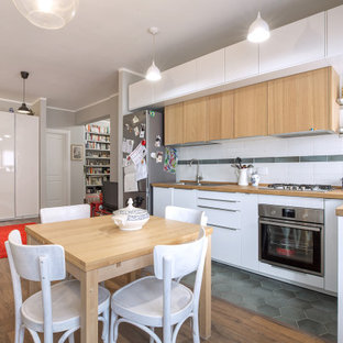 Idee per una cucina design di medie dimensioni con lavello da incasso, ante di vetro, ante bianche, top in legno, paraspruzzi bianco, paraspruzzi con piastrelle diamantate, elettrodomestici in acciaio inossidabile, pavimento in legno massello medio, nessuna isola, pavimento marrone e top beige
