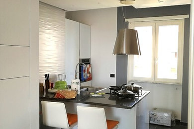 Design ideas for a small contemporary single-wall open plan kitchen in Naples with a built-in sink, glass-front cabinets, white cabinets, granite worktops, white splashback, metro tiled splashback, white appliances, ceramic flooring, a breakfast bar and grey floors.