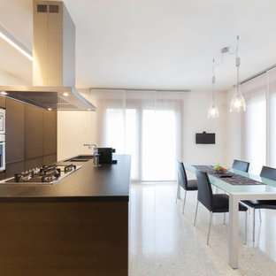 Esempio di una cucina contemporanea con lavello a doppia vasca, ante lisce, ante in legno scuro, elettrodomestici in acciaio inossidabile e top marrone