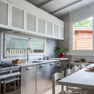 Design ideas for a mid-sized country single-wall eat-in kitchen in Florence with no island, an undermount sink, louvered cabinets, white cabinets, stainless steel appliances, light hardwood floors and beige floor.