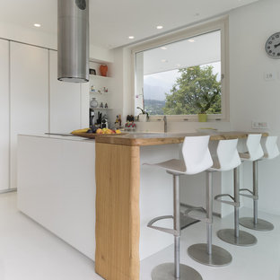 Immagine di una cucina minimal con ante lisce, ante bianche e pavimento bianco