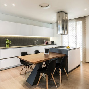 Design ideas for a mid-sized modern single-wall open plan kitchen in Bari with an integrated sink, open cabinets, white cabinets, quartz benchtops, stainless steel appliances, painted wood floors and with island.