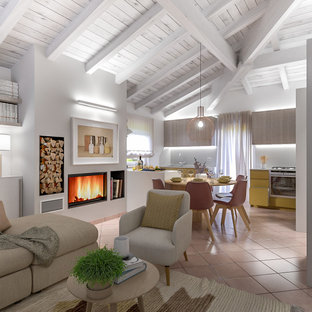 Design ideas for a mid-sized contemporary u-shaped open plan kitchen in Milan with a double-bowl sink, flat-panel cabinets, yellow cabinets, solid surface benchtops, grey splashback, glass sheet splashback, stainless steel appliances, terra-cotta floors, with island, pink floor and grey benchtop.