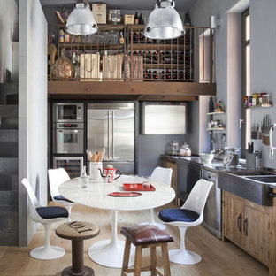 Idee per una cucina eclettica con lavello stile country, ante lisce, ante in legno scuro, elettrodomestici in acciaio inossidabile, parquet chiaro, nessuna isola, pavimento beige e top grigio
