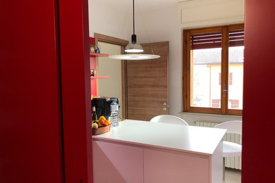 This is an example of a medium sized contemporary l-shaped enclosed kitchen in Other with a built-in sink, flat-panel cabinets, white cabinets, composite countertops, white splashback, white appliances, porcelain flooring, an island, white floors and white worktops.