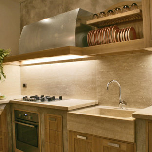This is an example of a mid-sized eclectic l-shaped eat-in kitchen in Florence with a single-bowl sink, recessed-panel cabinets, light wood cabinets, limestone benchtops, beige splashback, stone slab splashback, stainless steel appliances, porcelain floors, no island, yellow floor and beige benchtop.