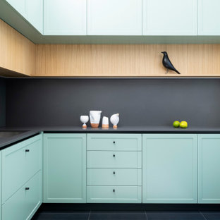 Inspiration for a mid-sized scandinavian l-shaped separate kitchen in Milan with an undermount sink, recessed-panel cabinets, green cabinets, quartz benchtops, grey splashback, engineered quartz splashback, stainless steel appliances, porcelain floors, no island, multi-coloured floor and grey benchtop.