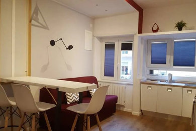 Open concept kitchen - small scandinavian light wood floor open concept kitchen idea in Naples with wood countertops