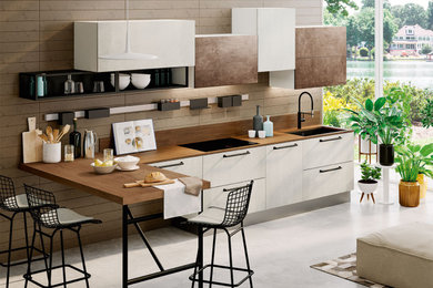 Exempel på ett mellanstort modernt linjärt kök, med en undermonterad diskho, släta luckor, vita skåp, laminatbänkskiva, svarta vitvaror, betonggolv, en köksö och grått golv