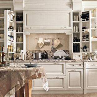 Mid-sized traditional l-shaped eat-in kitchen in Catania-Palermo with an undermount sink, raised-panel cabinets, white cabinets, granite benchtops, pink splashback, granite splashback, white appliances, marble floors, no island, pink floor, pink benchtop and recessed.