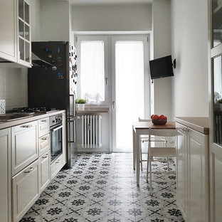 Inspiration for a mid-sized contemporary single-wall separate kitchen in Milan with a single-bowl sink, recessed-panel cabinets, white cabinets, laminate benchtops, white splashback, porcelain splashback, stainless steel appliances, porcelain floors, no island, multi-coloured floor and beige benchtop.