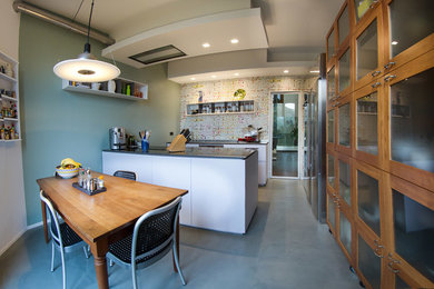 Idéer för att renovera ett mellanstort funkis kök och matrum, med släta luckor, vita skåp, flerfärgad stänkskydd och en köksö
