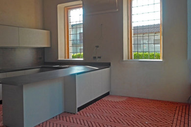 Idee per una grande cucina ad ambiente unico rustica con pavimento rosso e soffitto a volta