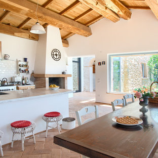 Ispirazione per una cucina abitabile mediterranea con paraspruzzi bianco, paraspruzzi con piastrelle diamantate, elettrodomestici in acciaio inossidabile, pavimento arancione, top grigio e soffitto in legno