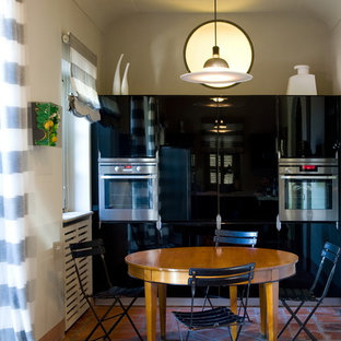 Design ideas for a modern galley separate kitchen in Turin with a drop-in sink, marble benchtops, stainless steel appliances, terra-cotta floors and red floor.